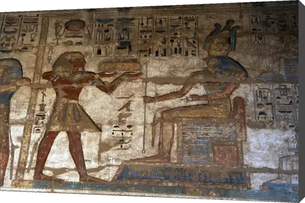 Temple of Ramses III. The pharaoh making offerings to god Ho