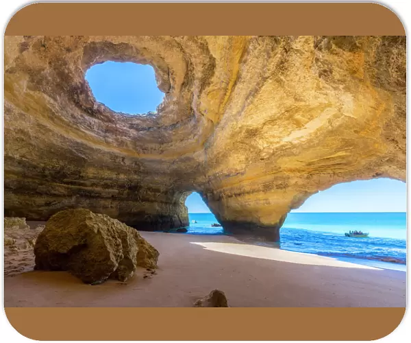 The sea caves of Benagil with natural windows on the clear waters of the Atlantic Ocean