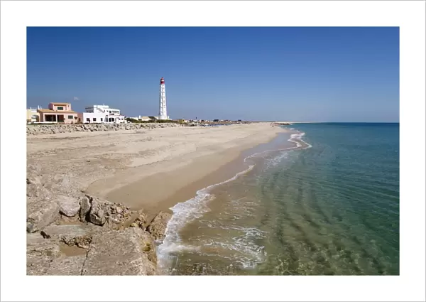 Lighthouse and beach of Ilha do Farol, Culatra barrier island, Olhao, Algarve, Portugal