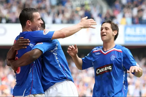 Rangers Triumph: Darcheville, Ferguson, and Furman: Celebrating the Third Goal Against Dundee United (3-1)
