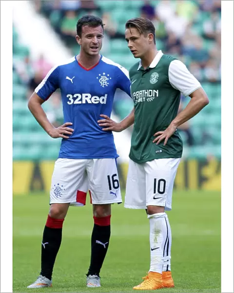 Deep in Thought: Halliday and Allan's Intense Conversation during Hibernian vs. Rangers (Petrofac Training Cup)