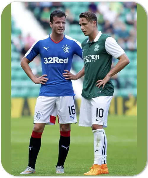 Deep in Thought: Halliday and Allan's Intense Conversation during Hibernian vs. Rangers (Petrofac Training Cup)