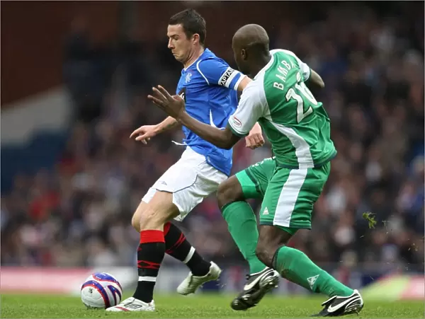 Intense Rivalry: Bamba vs Ferguson's Battle for the Ball (Rangers 1-0 Hibernian)