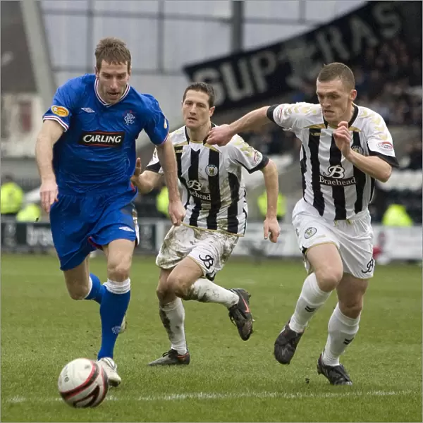 Intense Battle: Rangers Kirk Broadfoot Evades Challenges from St. Mirren's Lee Mair and David Barron in Scottish Cup Fifth Round