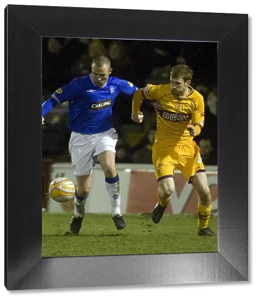 Intense Rivalry: Kenny Miller vs Mark Reynolds in the Motherwell vs Rangers Clydesdale Bank Scottish Premier League Match (1-1)
