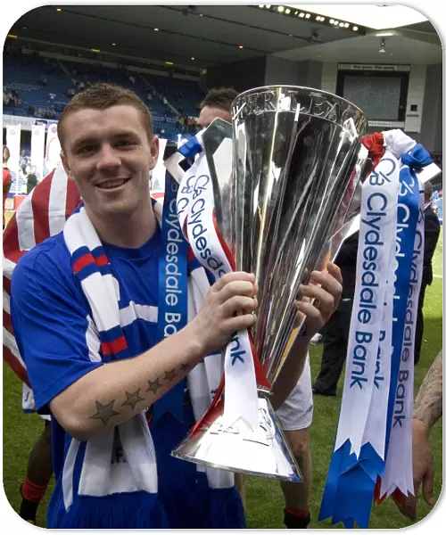 Rangers Football Club: SPL Champions - John Fleck's Triumphant Moment with the Trophy at Ibrox Stadium