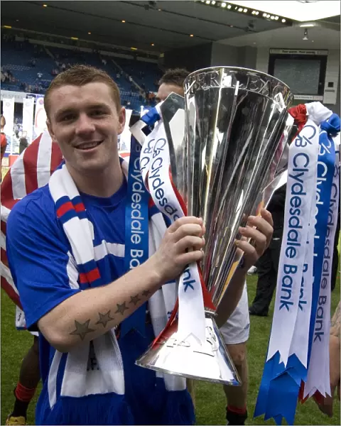 Rangers Football Club: SPL Champions - John Fleck's Triumphant Moment with the Trophy at Ibrox Stadium