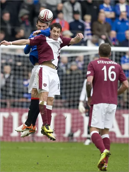 Leap of Triumph: Lee McCulloch Soars Over Rudi Skacel for a 1-0 Rangers Victory