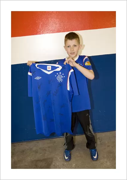 Family Fun at Ibrox: Marc Dickson's Exciting Shirt Winning Moment during Rangers vs. Heart of Midlothian Match