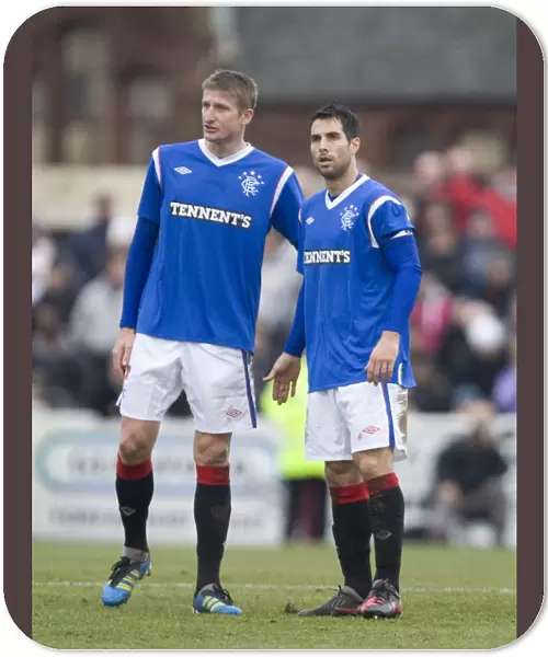 Deep in Thought: Dorin Goian and Carlos Bocanegra's Intense Conversation Amidst Rangers 4-0 Scottish Cup Triumph Over Arbroath