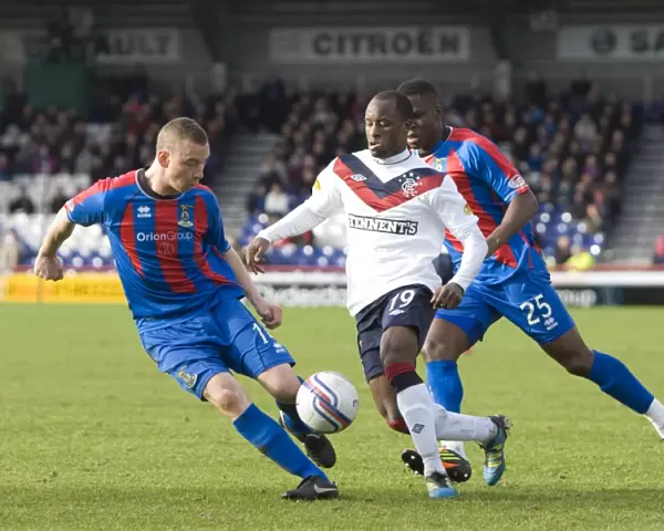 Rangers Sone Aluko Faces Off Against Inverness Defenders Nick Ross and Claude Gnakpa in Intense Clydesdale Bank Scottish Premier League Clash (1-4 in Favor of Rangers)