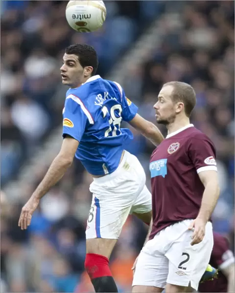 Rangers vs Hearts: Dramatic Clash between Salim Kerkar and Jamie Hammill at Ibrox Stadium in the Scottish Premier League (1-2 in Favor of Hearts)