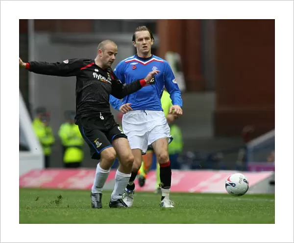 Intense Clash: Rangers Sasa Papac vs Inverness Caledonian Thistle's Graham Bayne in a 2-0 Clydesdale Bank Premier League Match at Ibrox