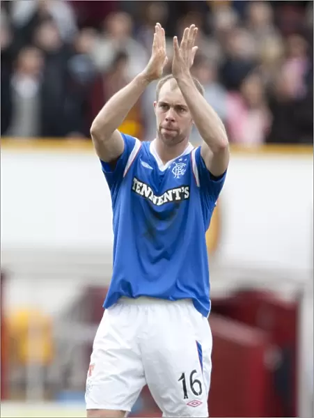 Steven Whittaker's Triumphant Applause: Rangers Victory Over Motherwell in the Scottish Premier League (2-1)