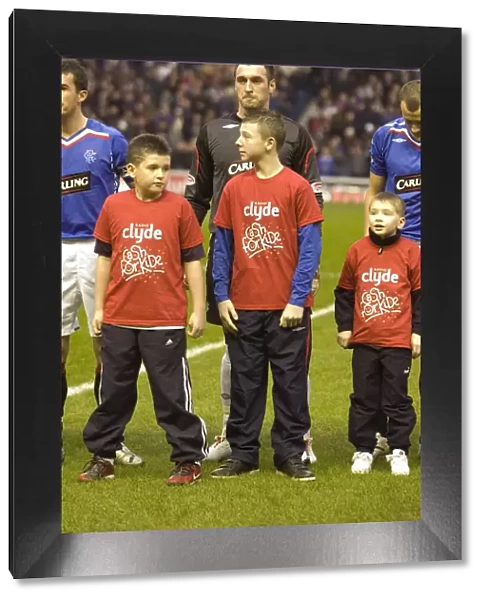 Rangers Football Club: Celebrating a 2-1 Victory Over Hearts with Cash for Kids Mascot at Ibrox