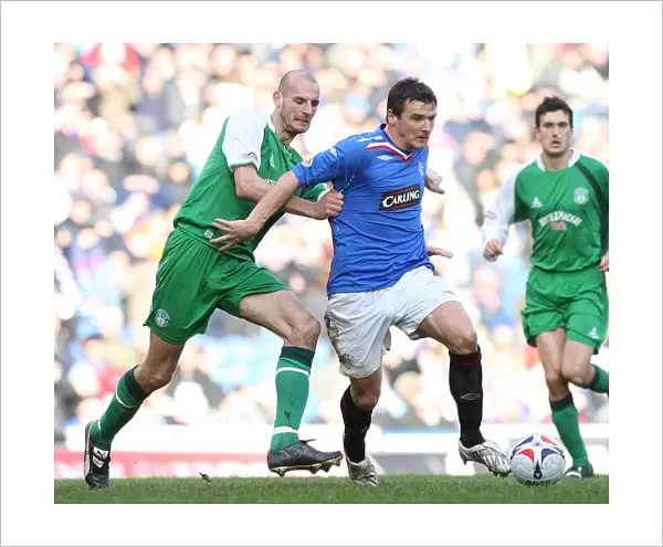 Rangers vs. Hibernian: A Fierce Battle for the Ball in the Scottish Cup Fifth Round Replay at Ibrox - Rangers Lead 1-0