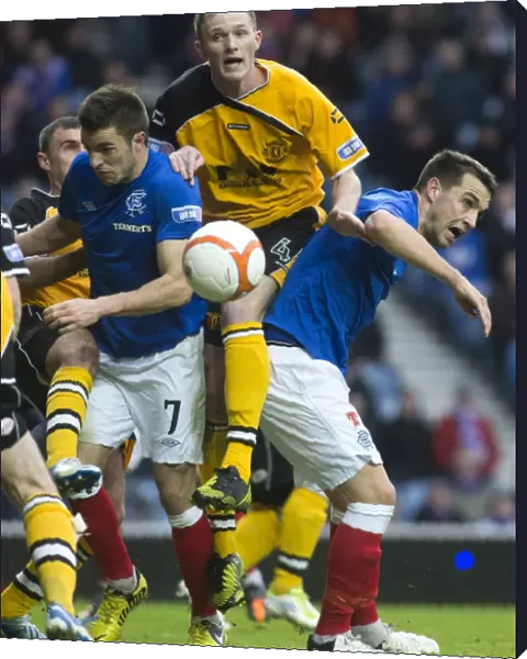 A Tight Battle at Ibrox Stadium: Rangers Andy Little and Chris Hegarty vs Annan Athletic's Martin McNiff
