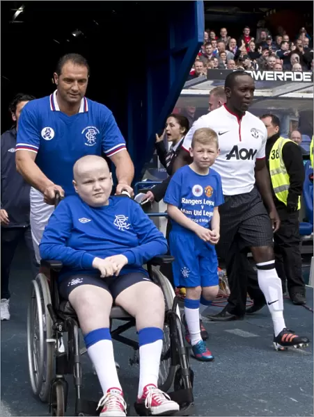 Rangers Legends vs Manchester United Legends: Amoruso and the Rangers Mascot - A Classic Soccer Showdown at Ibrox Stadium
