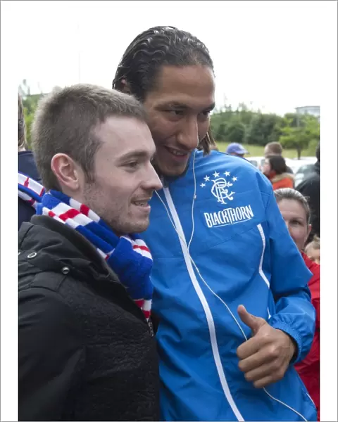 Rangers Bilel Moshni Celebrates Glory with Ecstatic Fan after Albion Rovers Defeat: 0-4 Rangers