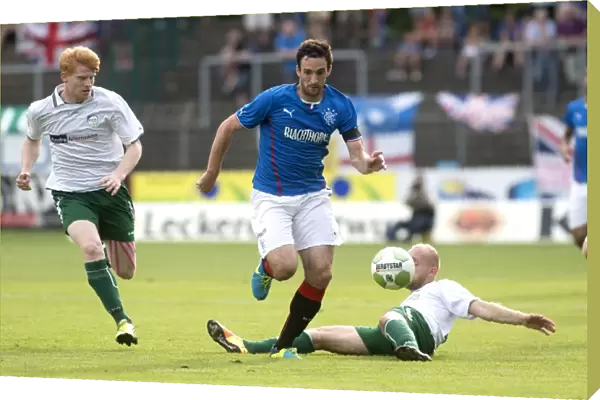 Rangers Take Early Lead Against FC Gutersloh 2000: Lee Wallace Faces a Tackle in Pre-Season Friendly