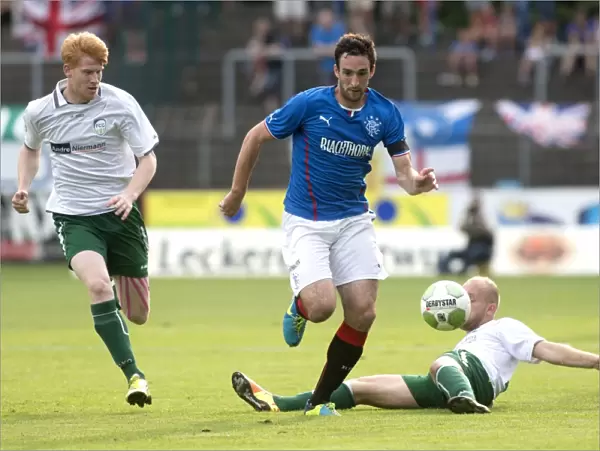 Rangers Take Early Lead Against FC Gutersloh 2000: Lee Wallace Faces a Tackle in Pre-Season Friendly