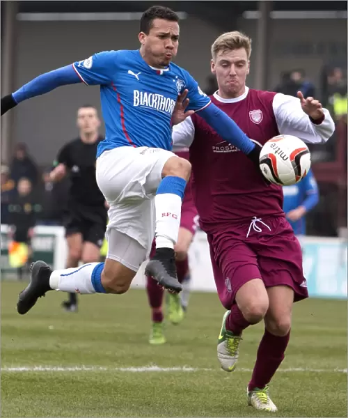 Intense Rivalry: Peralta and Travis Clash for Ball in Rangers vs Arbroath Scottish League One Match
