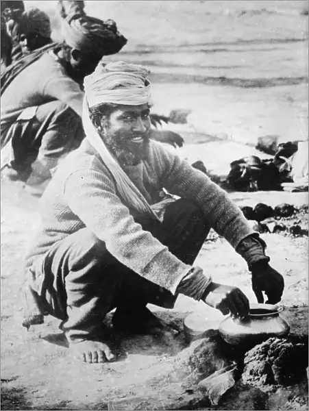 WWI: SOLDIER, c1914. A soldier of the Indian Army cooking over a fire in France