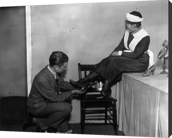 Shoe Fair. 5th September 1925: A waitress trying on a pair of the latest