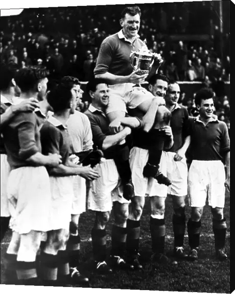 George Young Glasgow Rangers Captain is held aloft by team mates after winning the 1953
