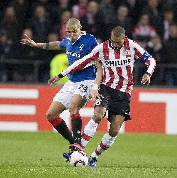 Battle at Philips Stadion: Bougherra vs Engelaar - A 0-0 Stalemate in Rangers vs PSV Eindhoven UEFA Europa League Round of 16 First Leg