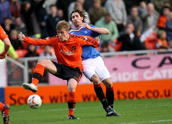 Dundee United's Jordan Robertson and Carlos Cuellar Clash in Intense Clydesdale Bank Premier League Match (2-1 in Favor of Dundee United)