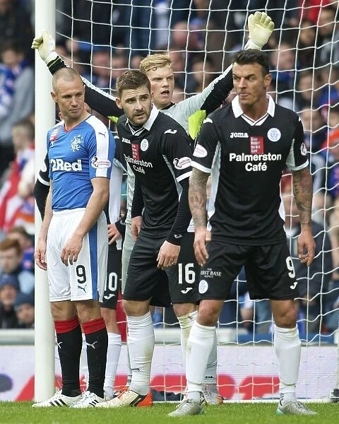 Kyle Hutton of Queen of the South Faces Off Against Rangers at Ibrox Stadium