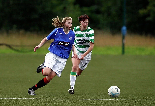 A Moment of Action: Lisa Swanson Slips Past Lisa Quigley in the Celtic vs Rangers Ladies Match at Lennoxtown, Glasgow (24-08-08)