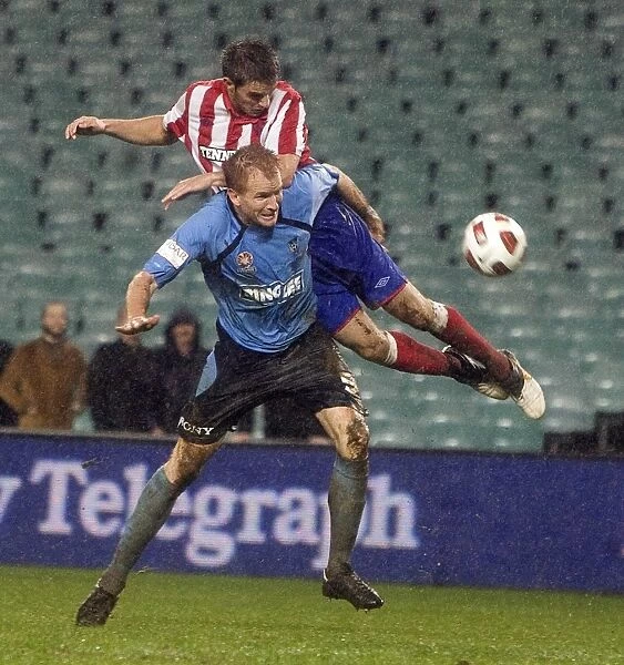 Rangers Andy Little Defies Sydney FC's Hayden Foxe: A Thrilling Leap at the Sydney Festival of Football 2010