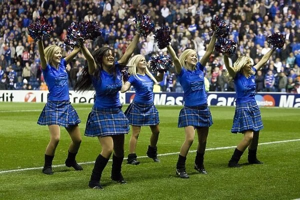 Rangers FC: Champions League Triumph - Ibrox Stadium Erupts in Cheers: Rangers Cheerleaders Celebrate Historic 1-0 Victory over Bursaspor