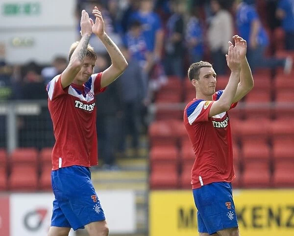 Rangers Football Club: Dorin Goian and Lee Wallace Celebrate 2-0 Victory over St. Johnstone with Fans