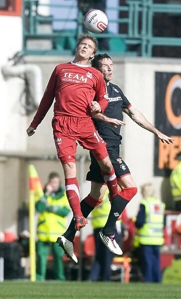 Thrilling Clash at Pittodrie Stadium: Kirk Broadfoot's Soaring Moment Over Darren Mackie (3-2) - Rangers Triumph