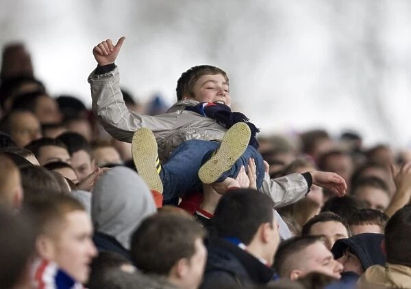 Young Rangers Fan Excitely Surfs the Crowd Amidst the Thrills of a 4-0 Scottish Cup Victory over Arbroath at Gayfield Park