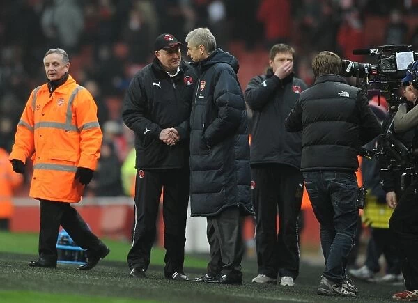 Arsenal manager Arsene Wenger shakes with Orient manager Russell Slade