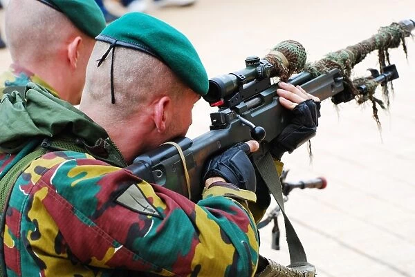 A Belgian paratrooper handling a sniper rifle
