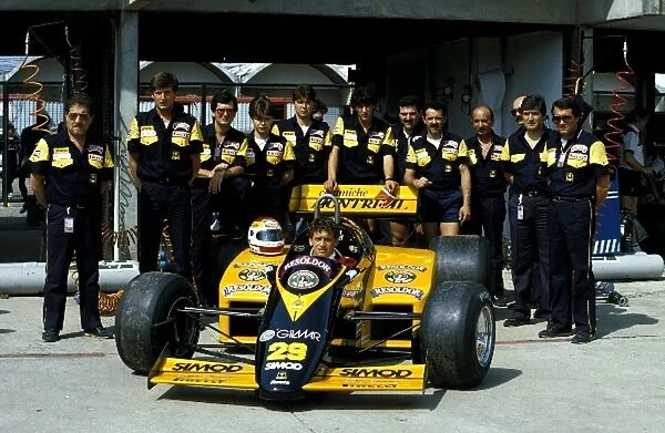 Formula One World Championship: Pierluigi Martini, Minardi Cosworth 185, poses with mechanics from the Minardi team who were making their debut