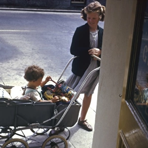 Girl with baby in pram, Cornwall
