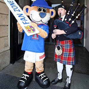 Clash of Fans: Rangers Broxi Bear and Piper Amidst the Soccer Passion at Glasgow's City Hall (Rangers vs. Barcelona)