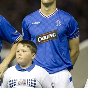 Ibrox Showdown: Rangers FC's Disappointing 1-4 Defeat Against Unirea Urziceni - Group G, Champions League Qualifying Stage: Steven Whittaker and the Rangers Mascot