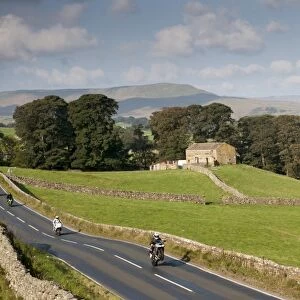 Motorcyclists on rural road speeding and doing wheelie, Hawes, Wensleydale, Yorkshire Dales N. P