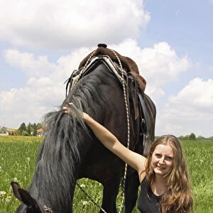 Young woman sitting next to her horse, Bavaria, Germany, Europe