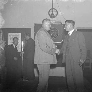 Two men shake hands at the Erith Hospital darts competition. 1939