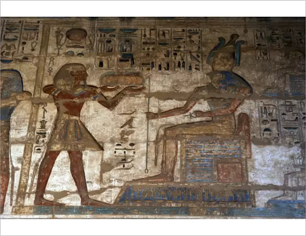 Temple of Ramses III. The pharaoh making offerings to god Ho