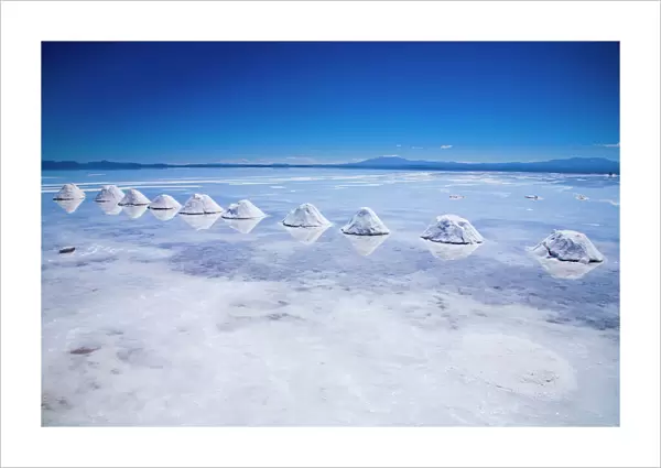 Bolivia, Southern Altiplano, Salar de Uyuni. Cones of salt stacked on the Salar de Uyuni salt flat