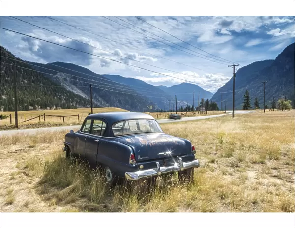 Old abandoned American car by road, British Columbia, Canada